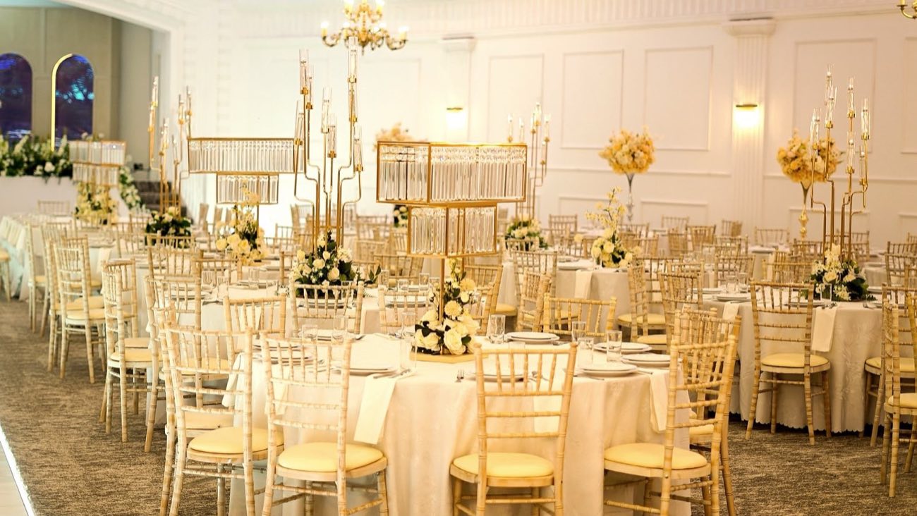 Banquet tables laid with gold candelabra and floral centrepieces at The Pavilion Dudley